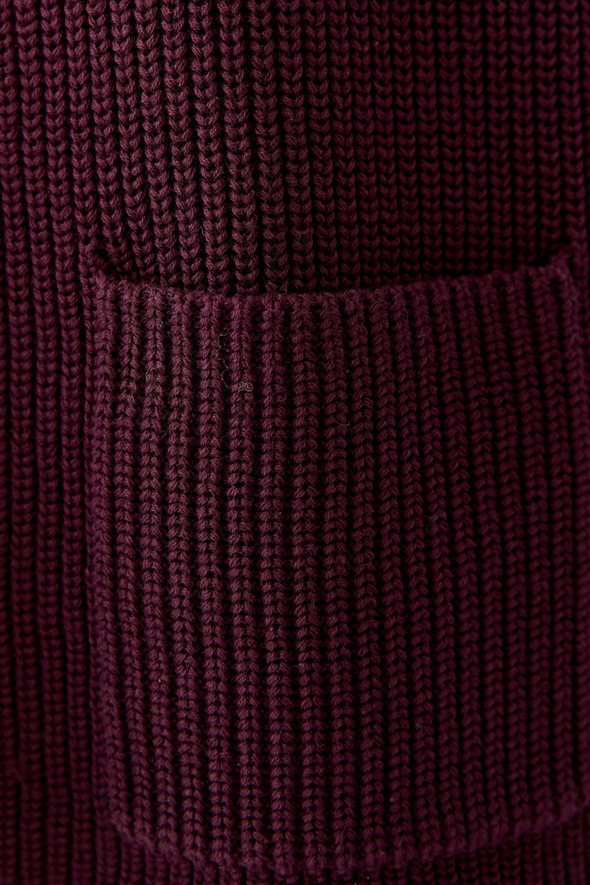 Cozy knit pullover in deep burgundy with a textured pocket detail, perfect for casual wear.