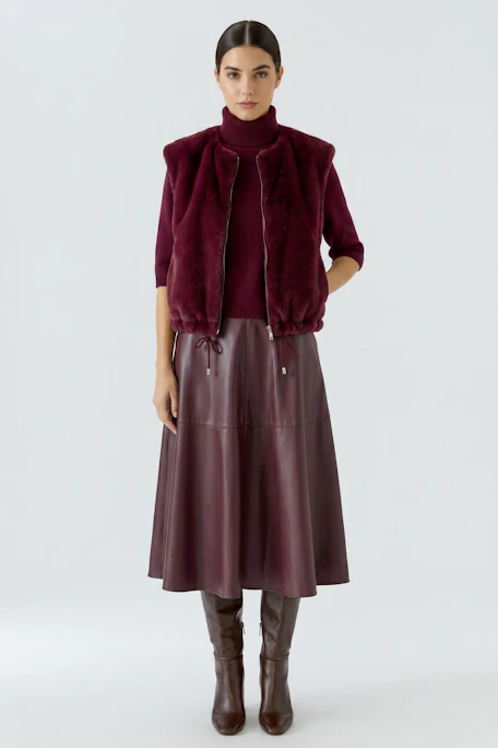 Plush burgundy vest with zip and drawstring hem, perfect for layering in cooler weather.