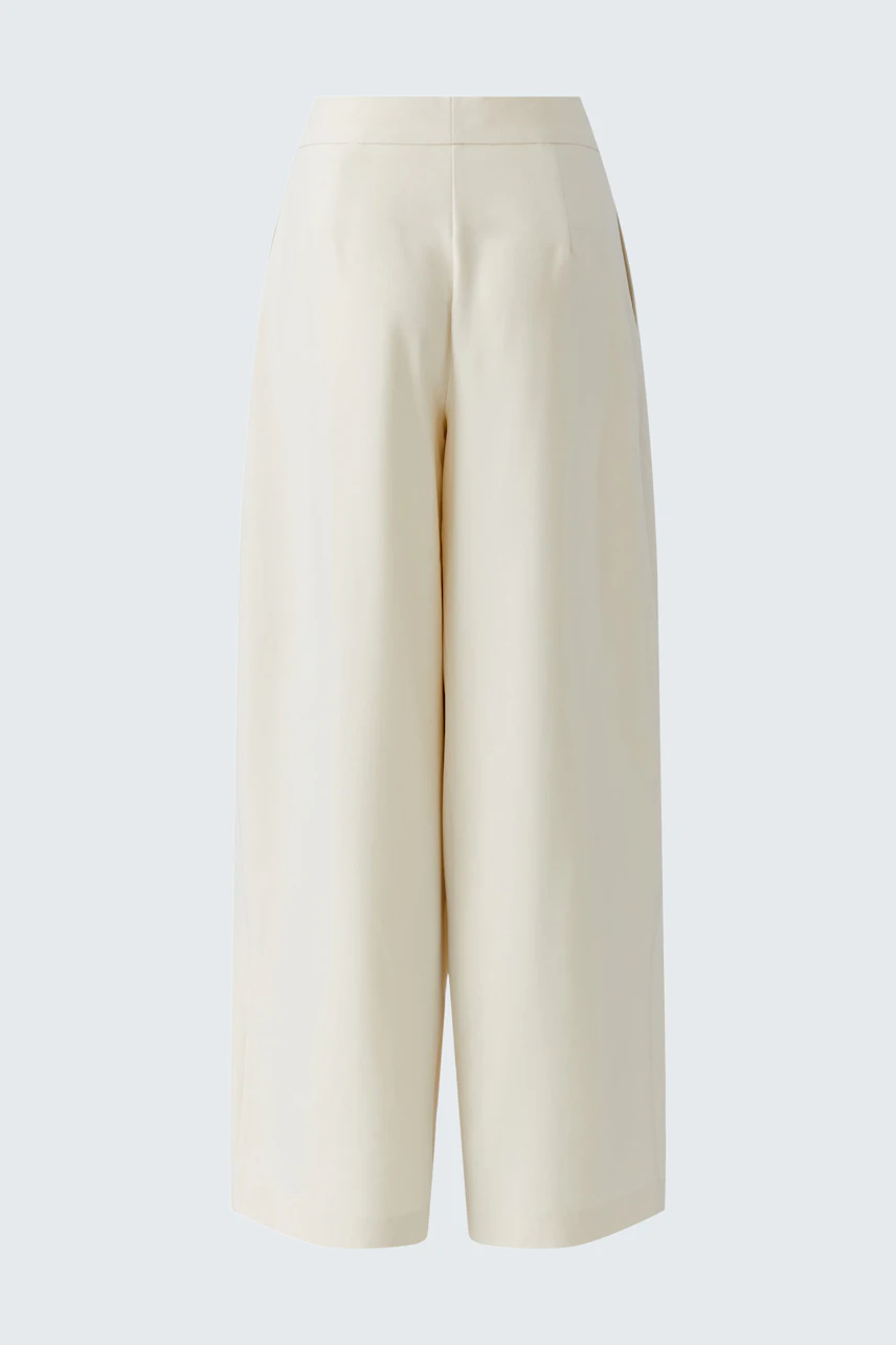 Pleated trousers: Cream-colored wide-leg trousers with a high waist, no model visible.