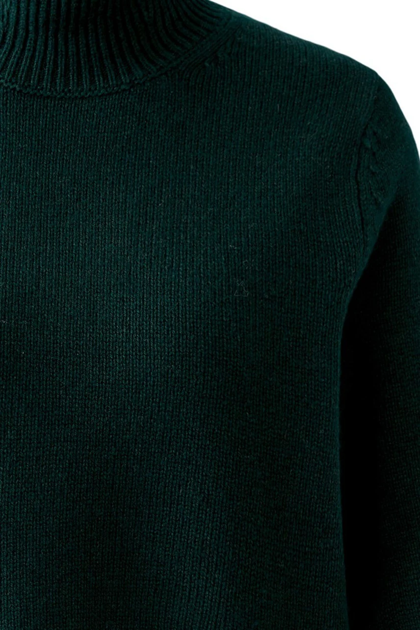 Woman in a green turtleneck pullover, showcasing a cozy and casual style.