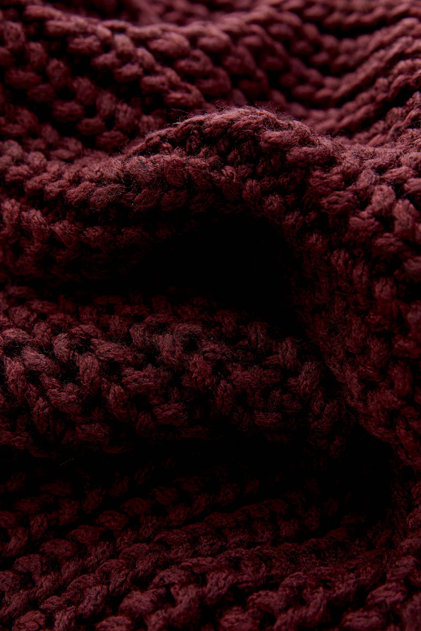 Weicher, grob gestrickter Schal in tiefem Rotton, ideal für kalte Tage. Perfekt zum Kuscheln und Wohlfühlen.