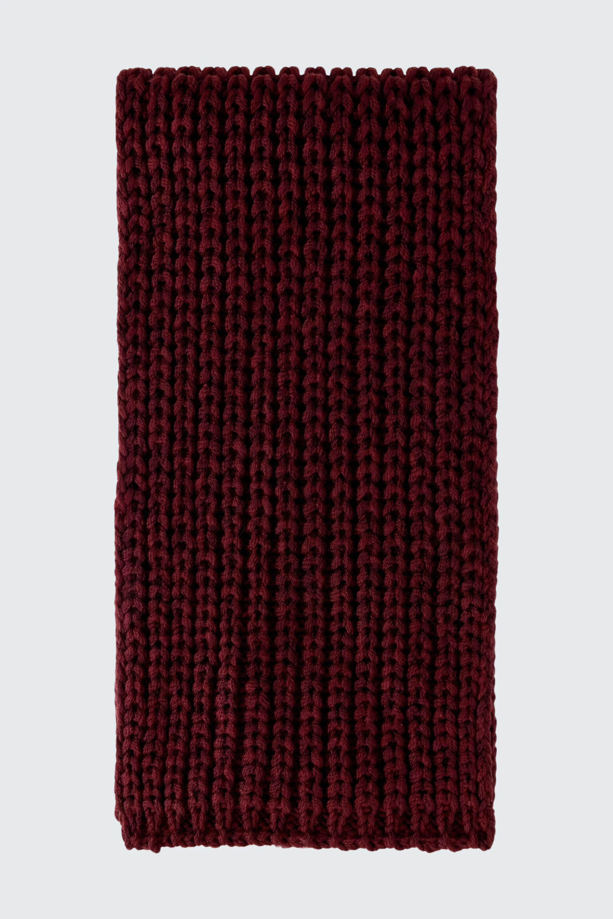 Cozy knitted scarf in deep burgundy, perfect for adding warmth and style to any outfit.