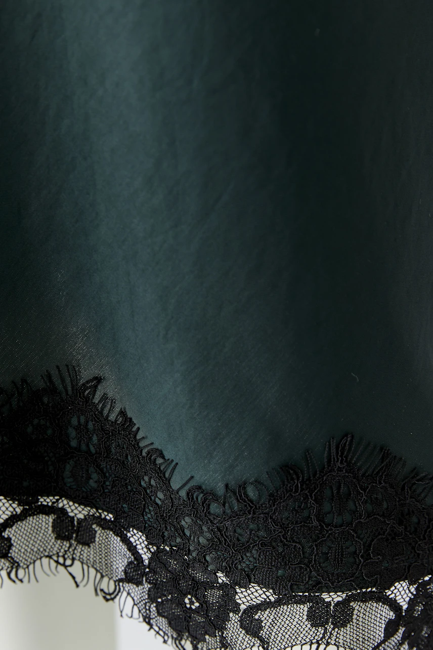 Black pencil skirt with lace trim, showcasing a sleek and modern design for versatile styling.