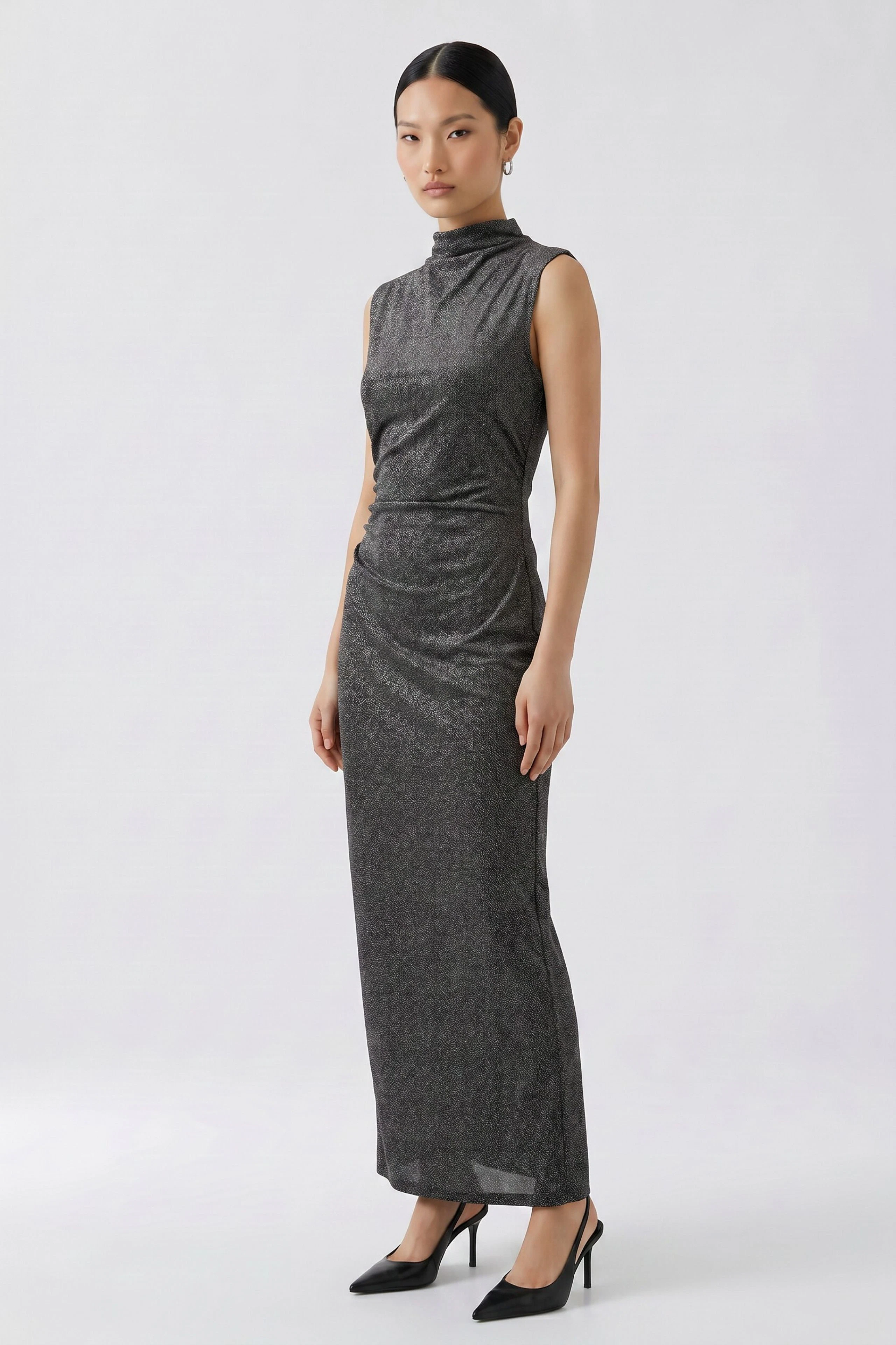 Sleeveless black dress: Simple, long black dress with a high neckline, perfect for versatile styling.