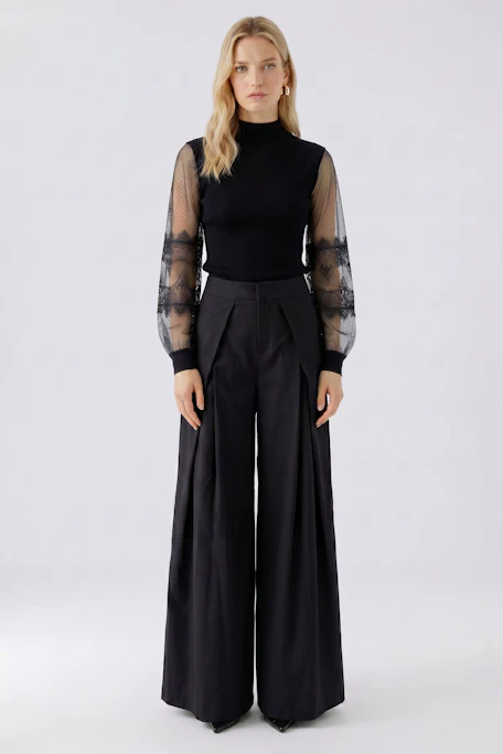 Black pullover with sheer lace sleeves, no model visible.