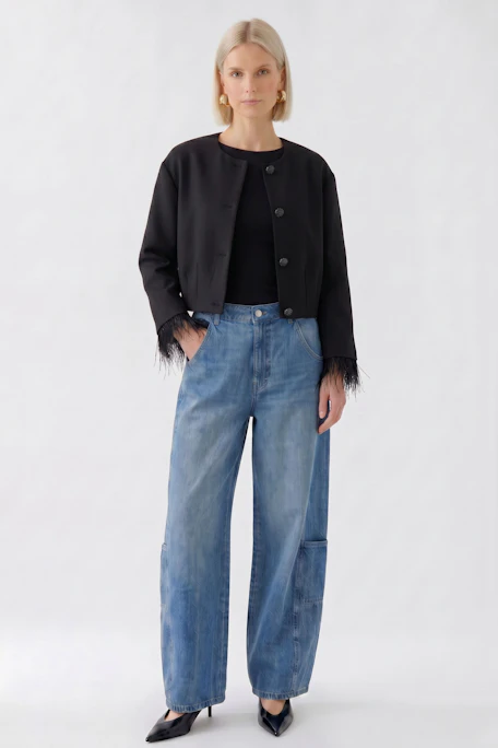 Black women's jacket with button closure and fringe details on sleeves, displayed without a model.