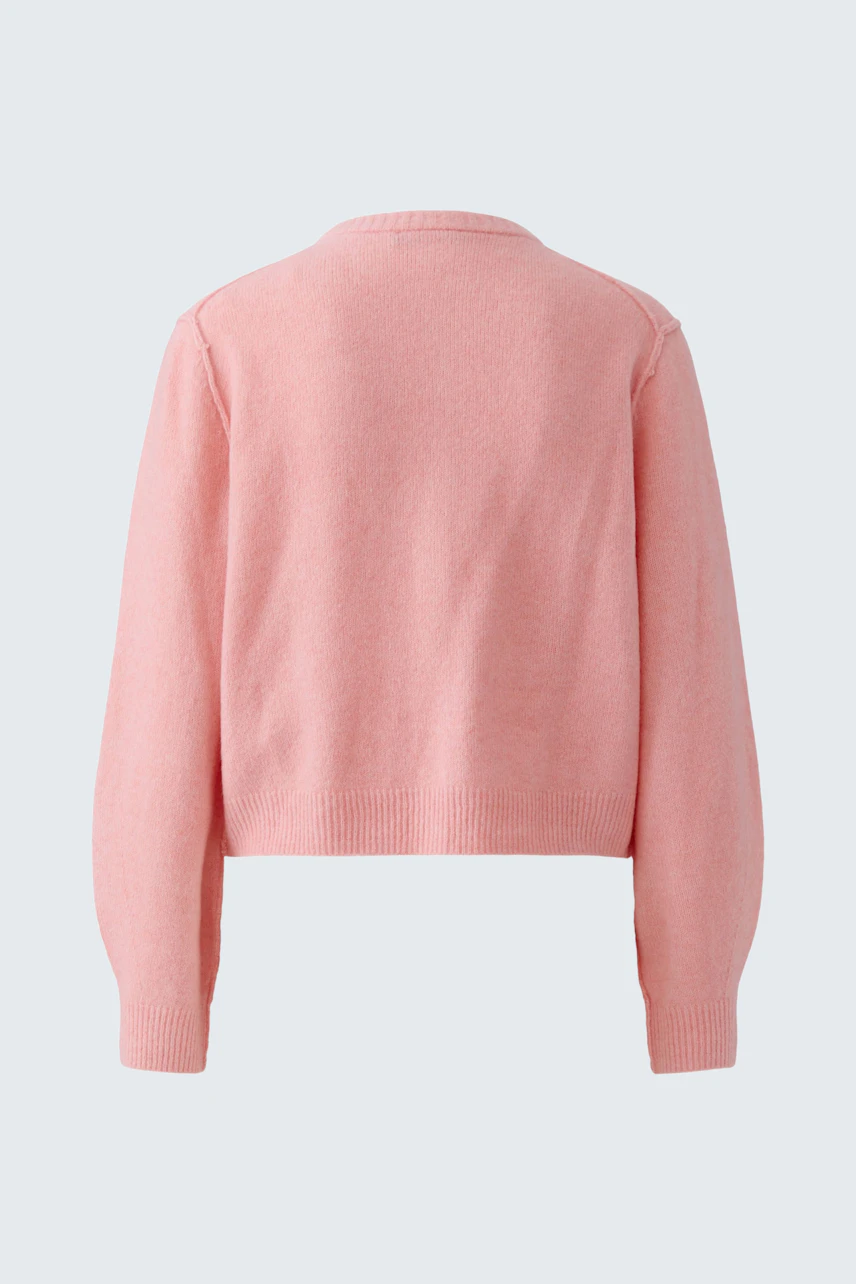 Casual women's cardigan in soft pink, shown from the back. Cozy knitwear for everyday comfort.