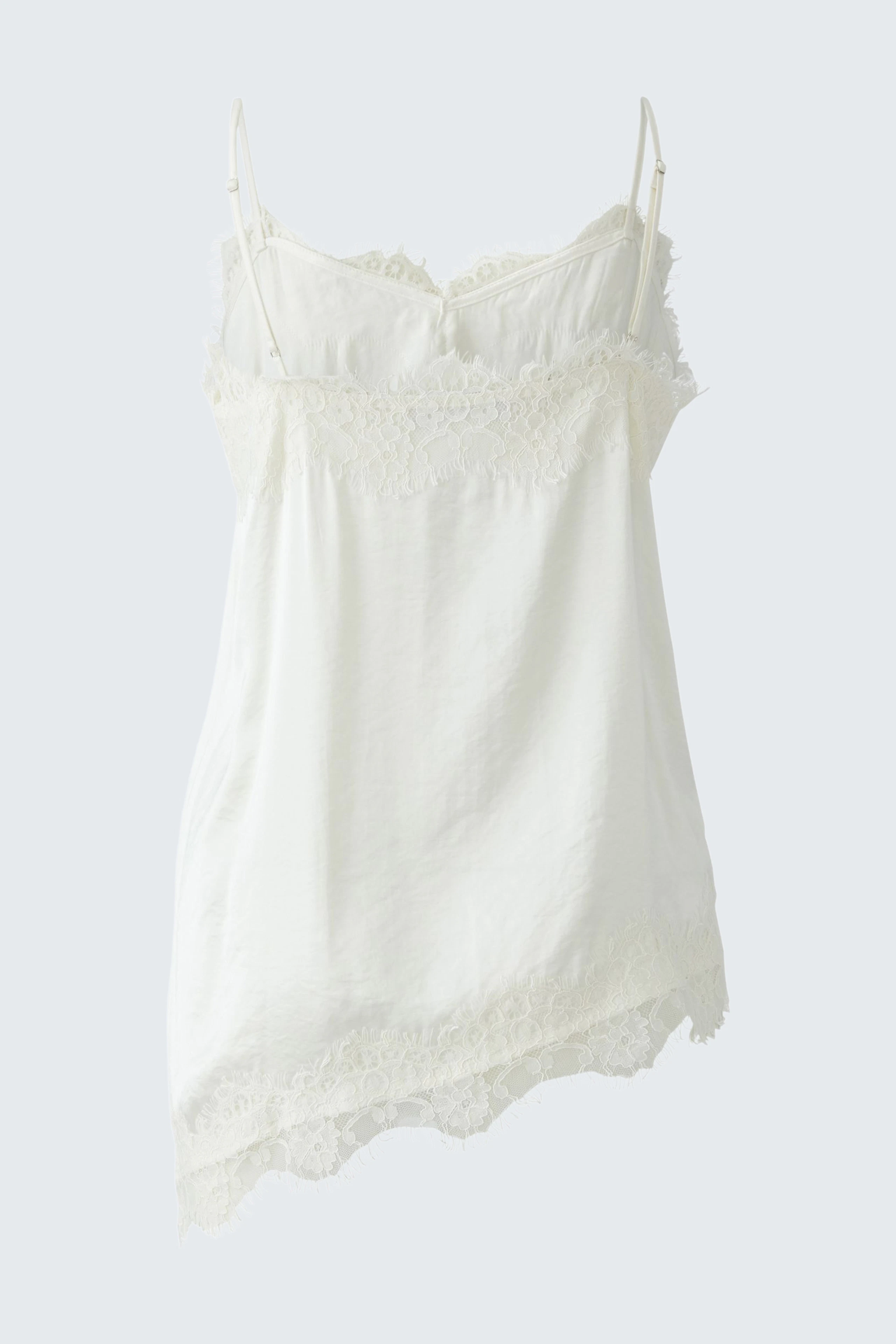 White lace-trimmed top: Sleeveless design with delicate lace details, perfect for layering or wearing alone.
