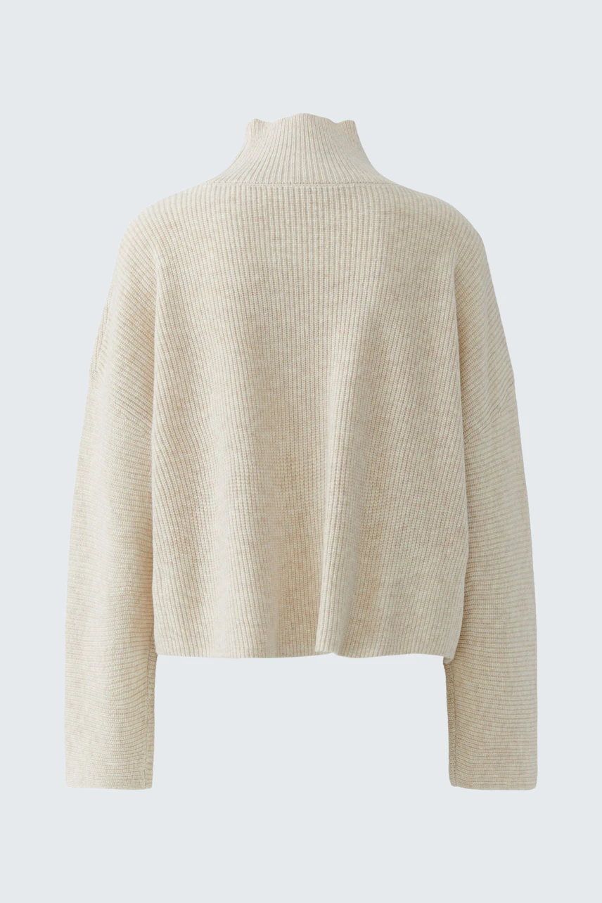 Cozy beige pullover: Soft knit fabric with a relaxed fit, perfect for casual comfort.