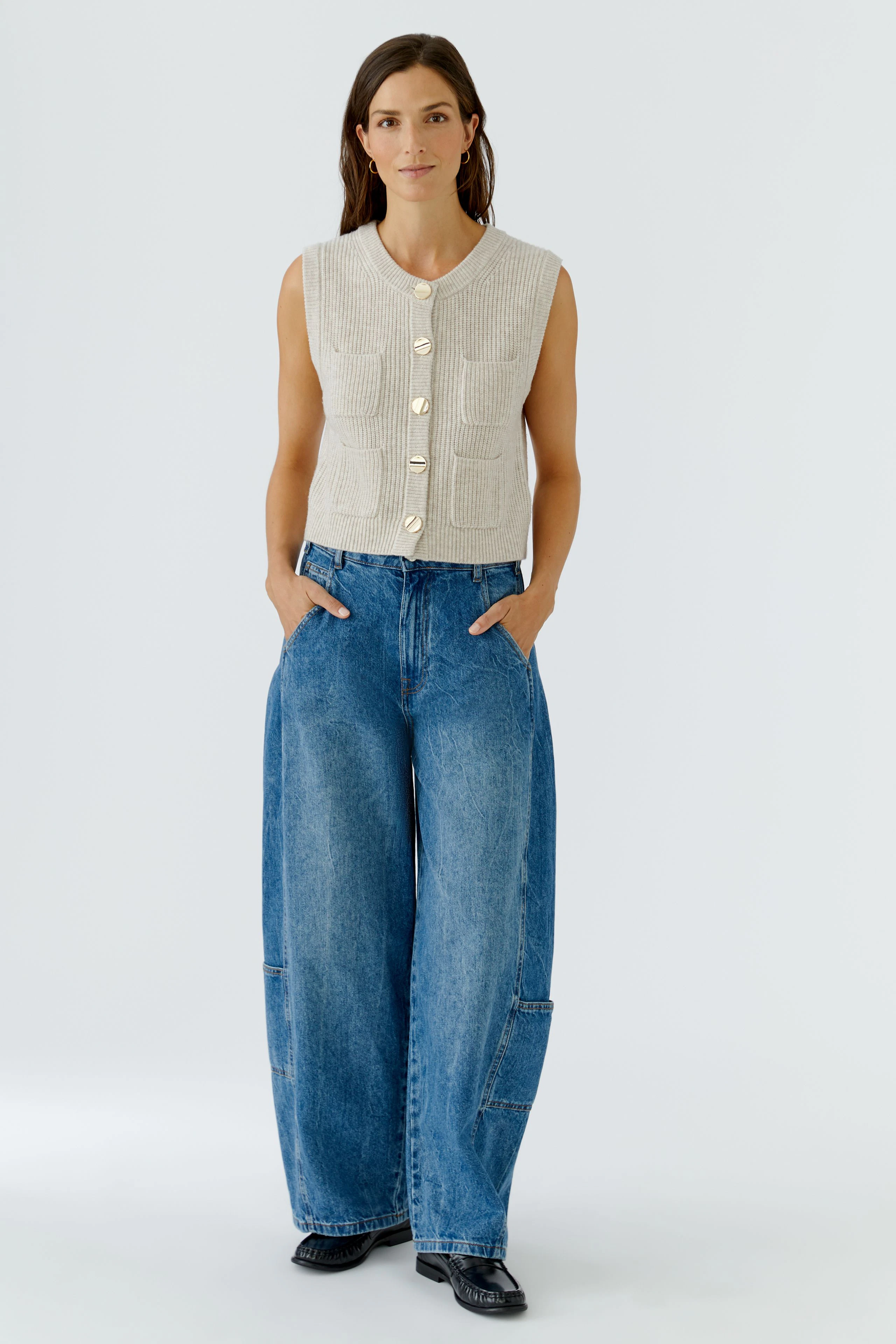 Casual knit vest: Beige sleeveless vest with ribbed texture and button front, perfect for layering.